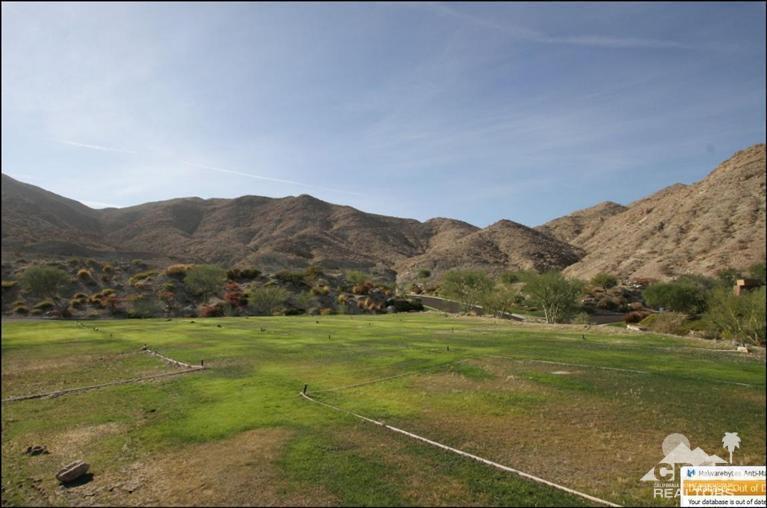 47 Sky Ridge Road Rancho Mirage, CA 92270 - Photo 3 of 10 a view of a grassy field with mountains in the background