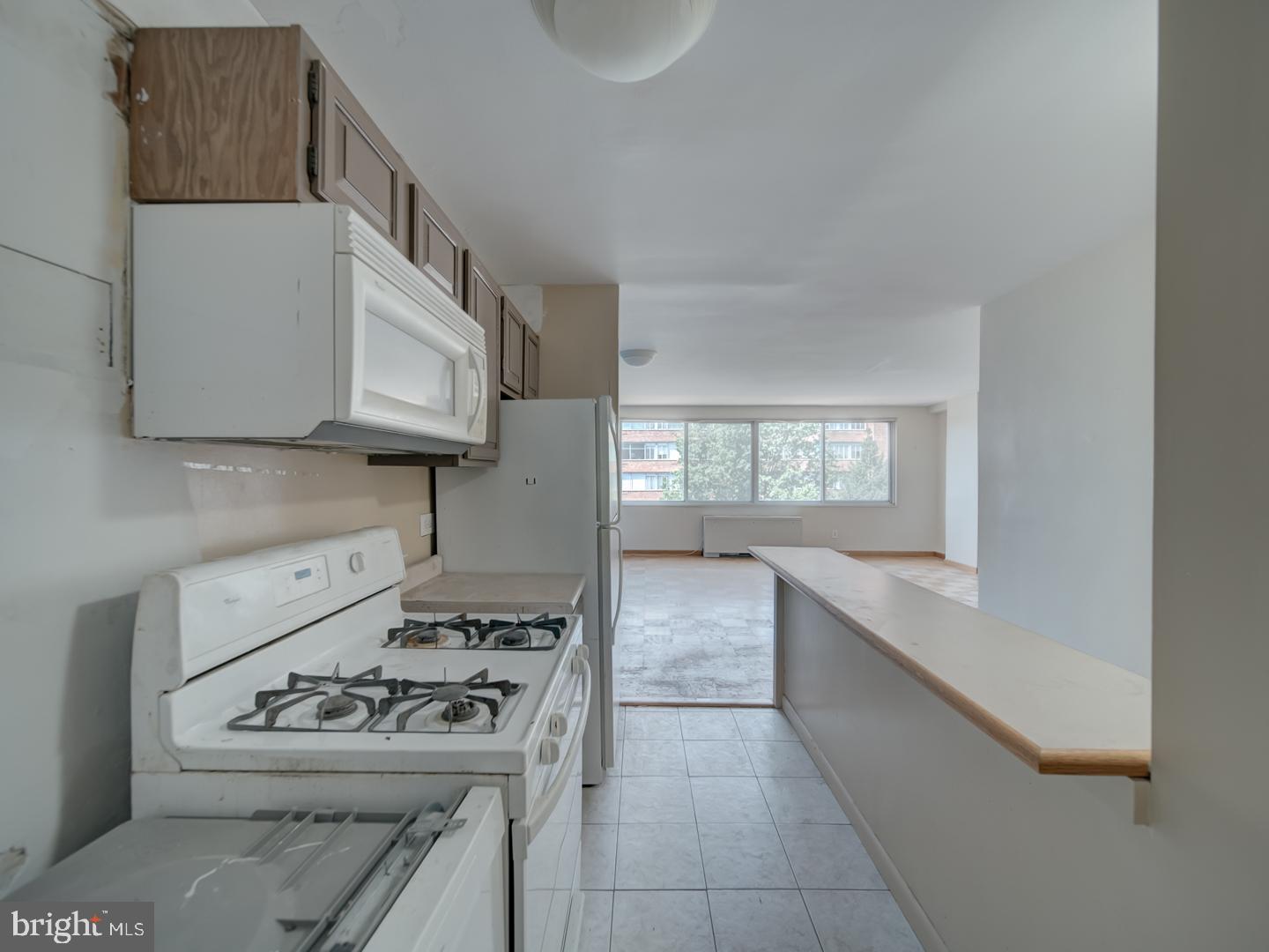 2829 Connecticut Avenue Northwest, Unit 606 Washington, DC 20008 - Photo 10 of 28 a kitchen with stainless steel appliances granite countertop a stove a sink and a microwave