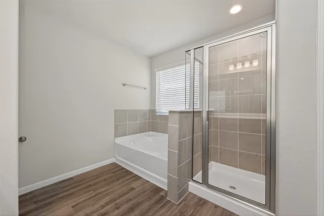 a bathroom with a bathtub and a shower