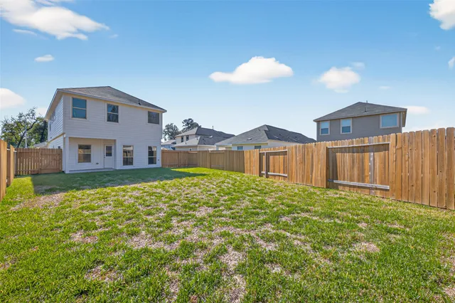 a view of a house with wooden fence