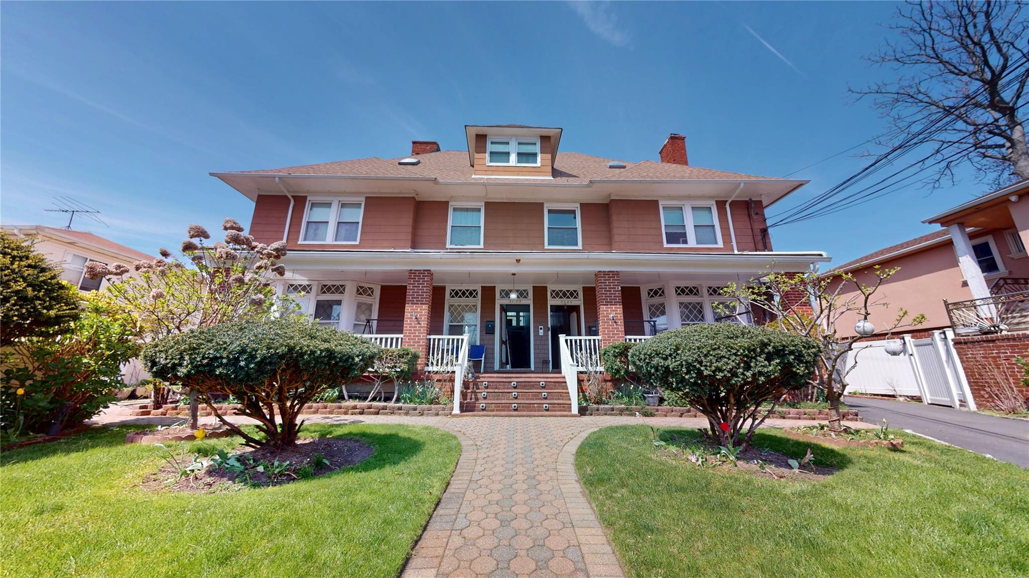 31-06 Healy Avenue Queens, NY 11691 - Photo 1 of 34 Traditional style home with a chimney, a porch, and a front lawn