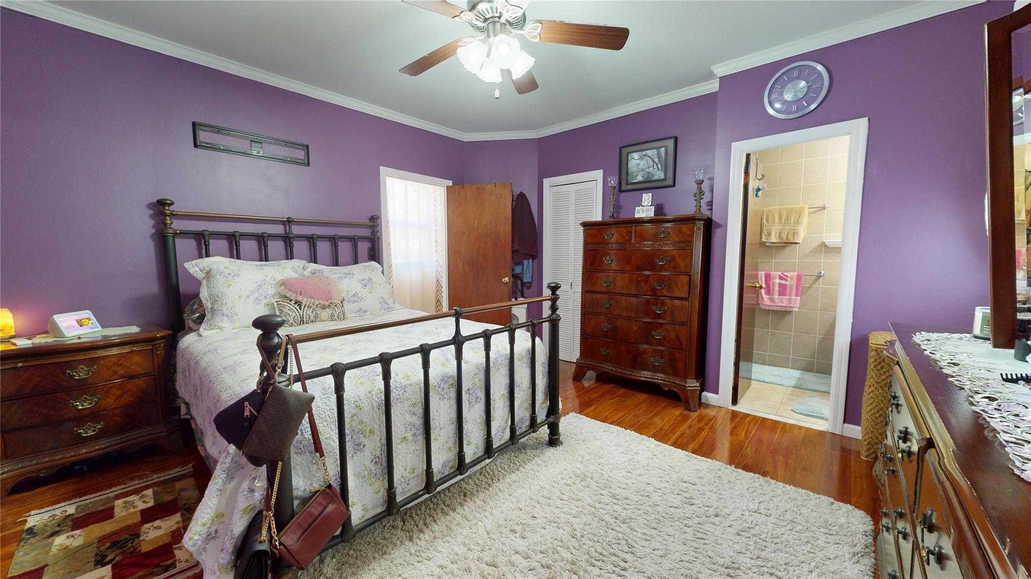 31-06 Healy Avenue Queens, NY 11691 - Photo 14 of 34 Bedroom featuring a closet, a ceiling fan, ornamental molding, wood finished floors, and ensuite bathroom