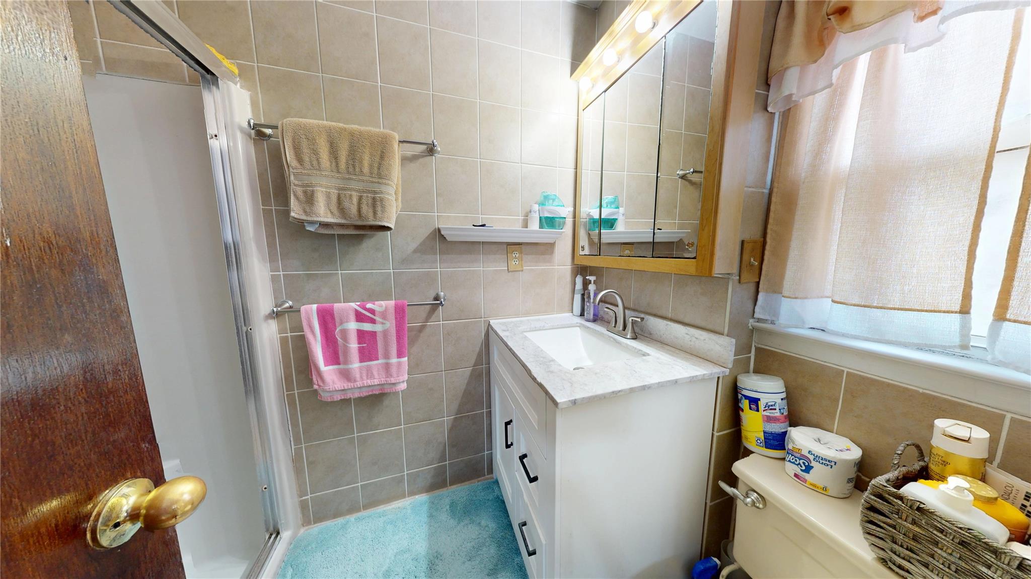 31-06 Healy Avenue Queens, NY 11691 - Photo 15 of 34 Bathroom featuring tile walls, a stall shower, and vanity