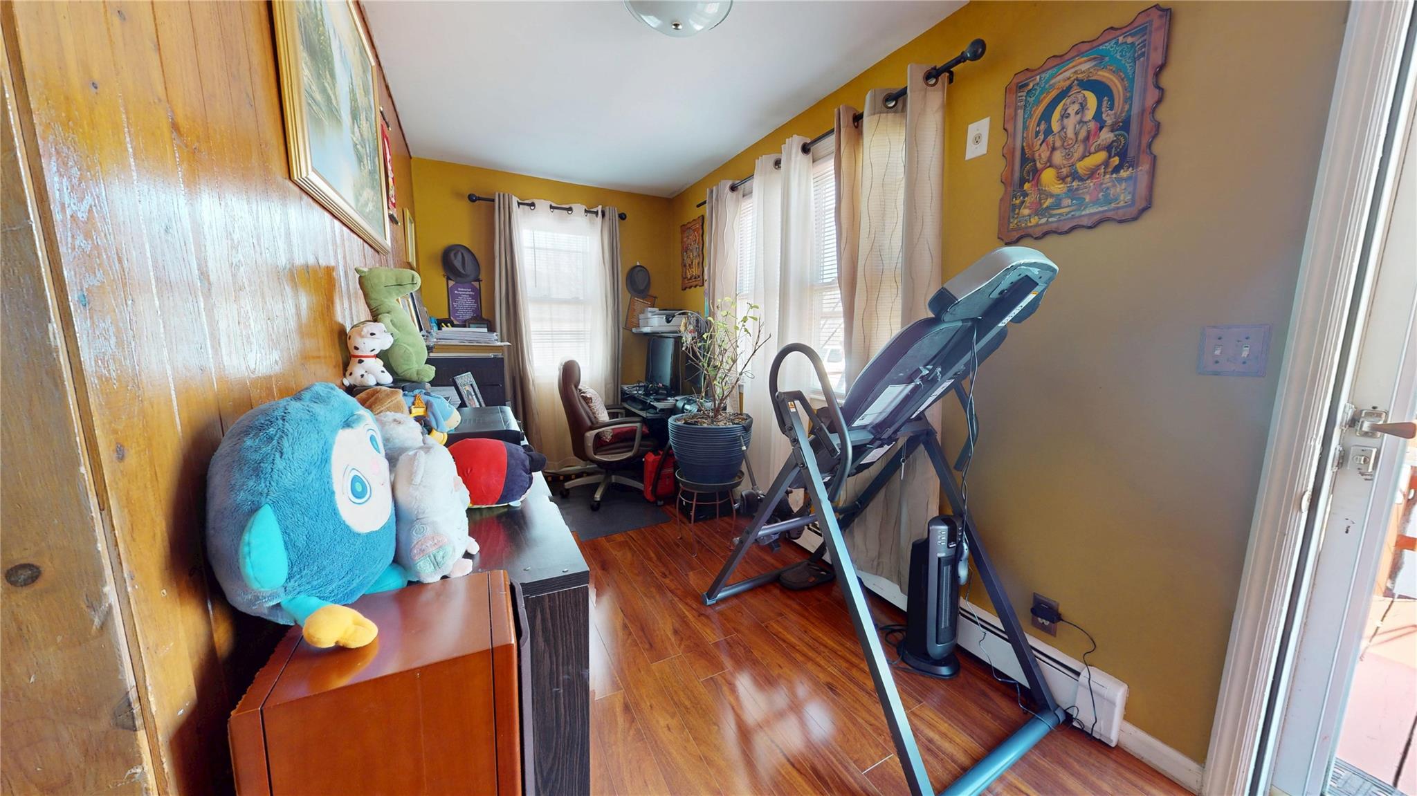 31-06 Healy Avenue Queens, NY 11691 - Photo 19 of 34 Exercise area featuring a baseboard heating unit and wood finished floors