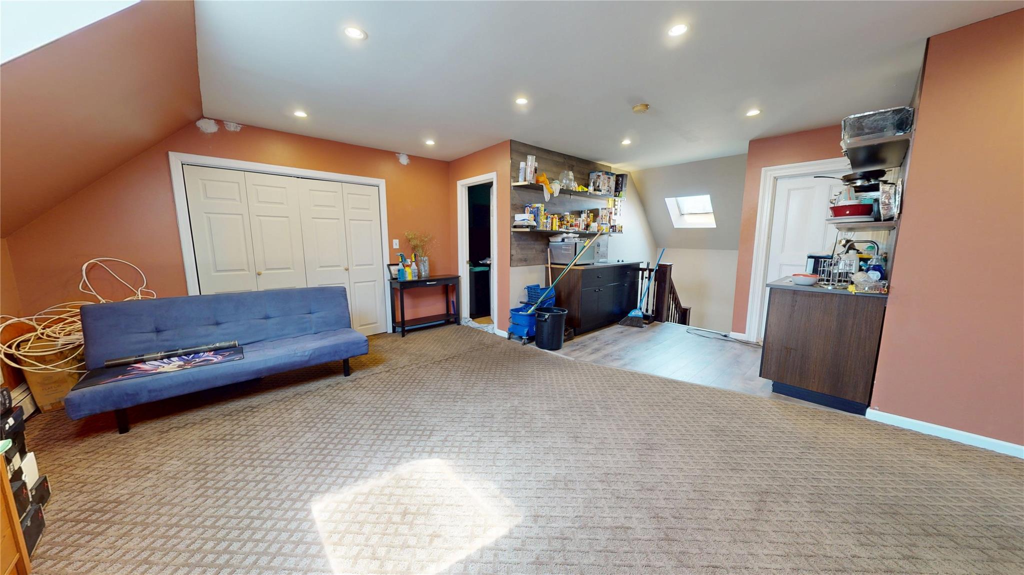 31-06 Healy Avenue Queens, NY 11691 - Photo 25 of 34 Living area featuring lofted ceiling with skylight, wood finished floors, recessed lighting, and baseboards