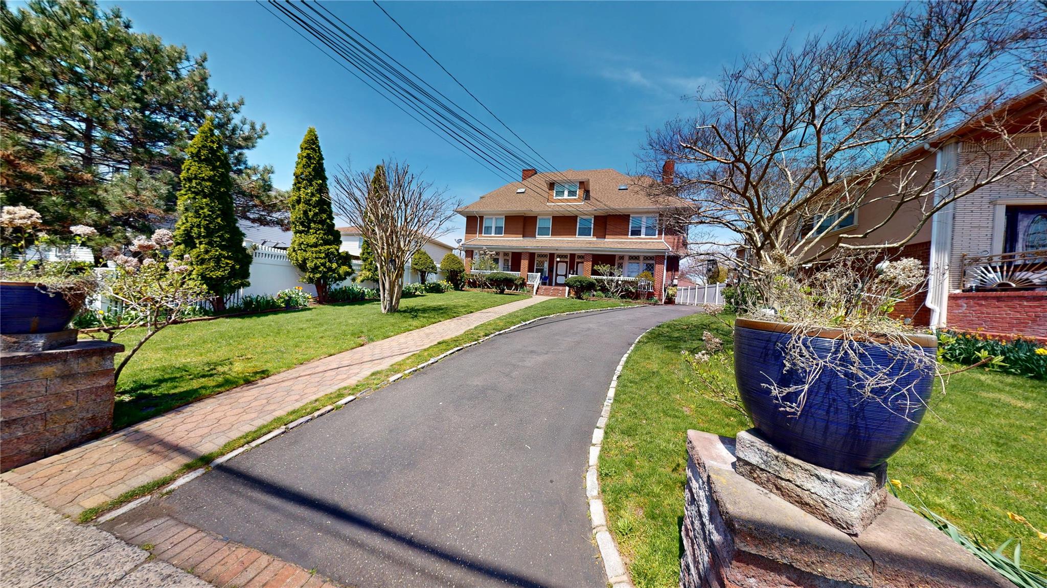 31-06 Healy Avenue Queens, NY 11691 - Photo 33 of 34 View of front of house with fence, brick siding, and a front lawn