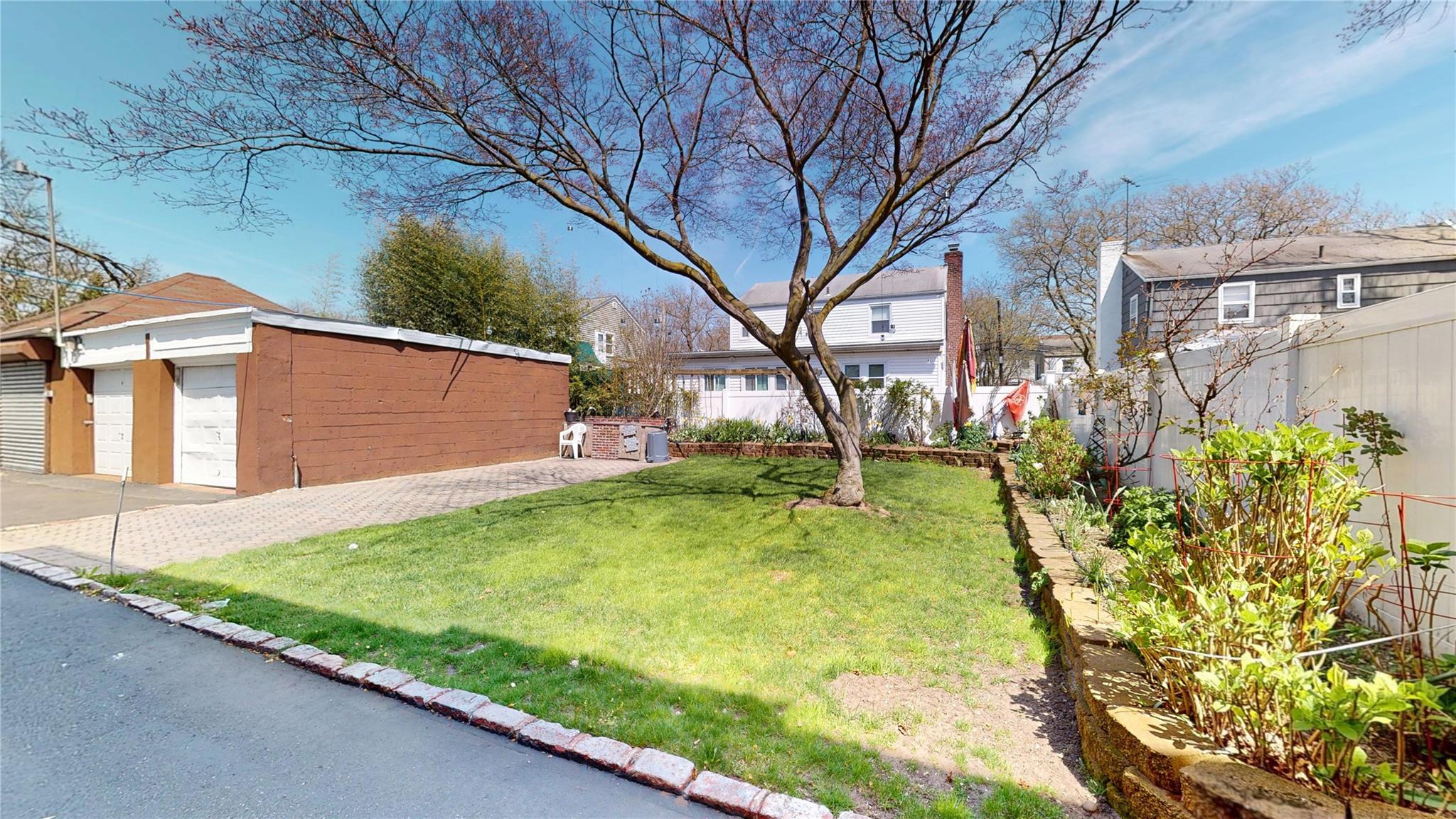31-06 Healy Avenue Queens, NY 11691 - Photo 5 of 34 View of yard with an outbuilding, a detached garage, and fence
