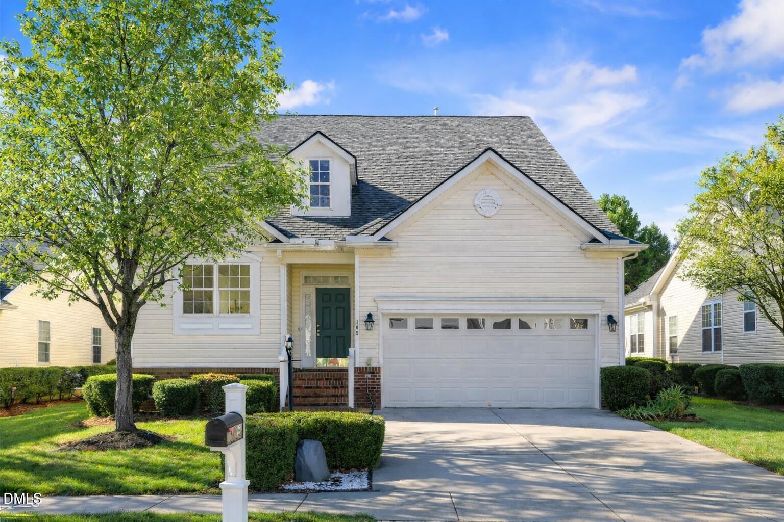 105 Rockport Ridge Way Cary, NC 27519 - Photo 1 of 43 a view of a white house next to a yard with potted plants