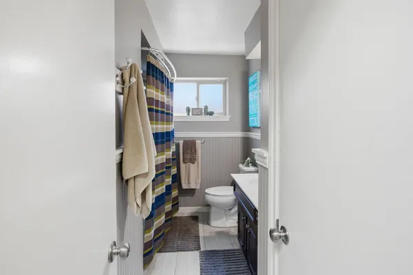 a bathroom with a toilet and a shower