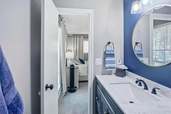 a en suite bathroom with a sink and a mirror