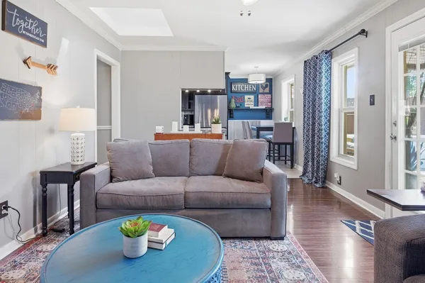 a living room with furniture and wooden floor