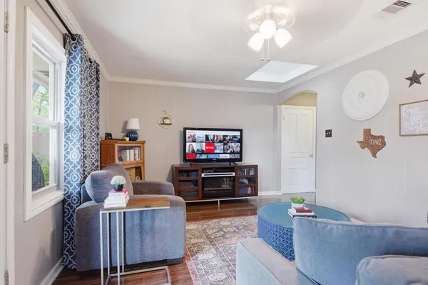 a living room with furniture and a flat screen tv