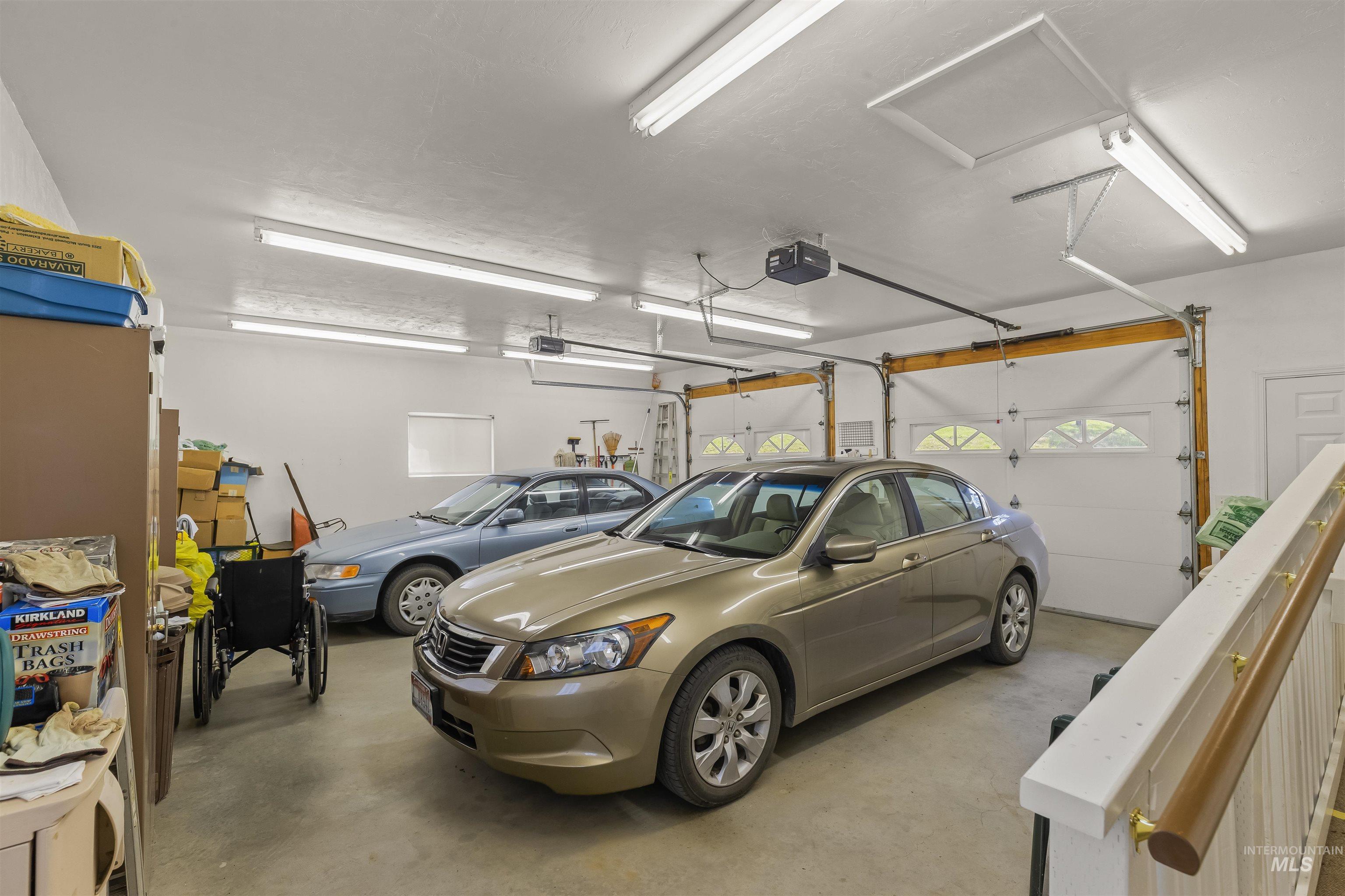 743 Wall Crk Road Stites, ID 83552 - Photo 31 of 48 Spacious two-car garage featuring a concrete floor, two automatic garage door openers, and multiple fluorescent light fixtures
