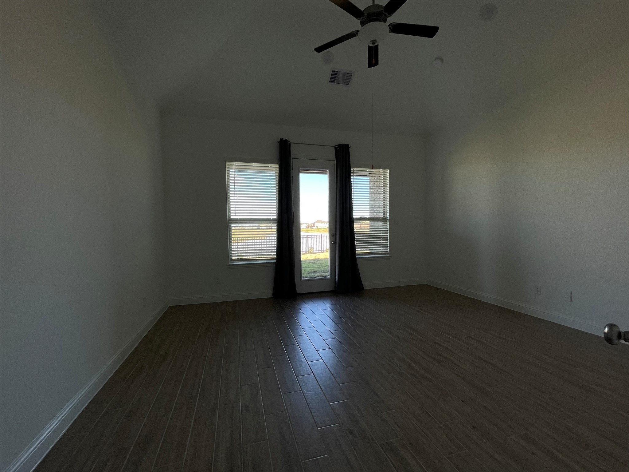 29806 Cherry Vine Road Katy, TX 77494 - Photo 13 of 30 a view of an empty room with wooden floor and windows