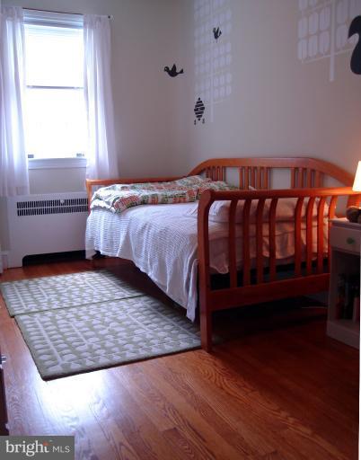 331 Murdock Road Baltimore, MD 21212 - Photo 8 of 19 a bed sitting in a bedroom next to a window