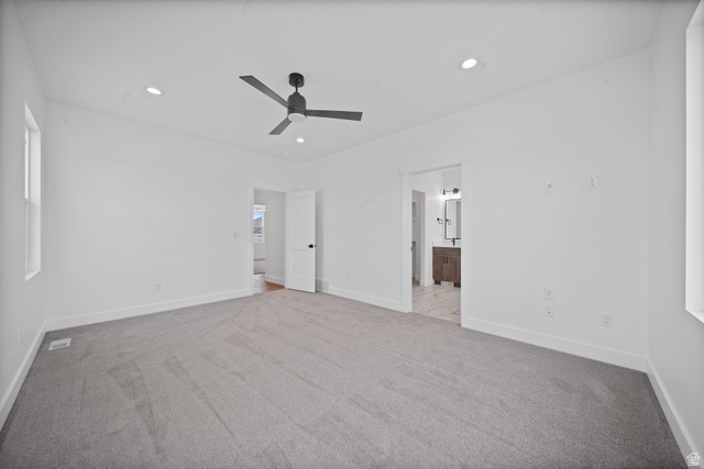 1117 East Shilow Road, Unit 106 Erda, UT 84074 - Photo 7 of 21 Spacious room featuring light gray carpeting, crisp white walls, and a contemporary black ceiling fan
