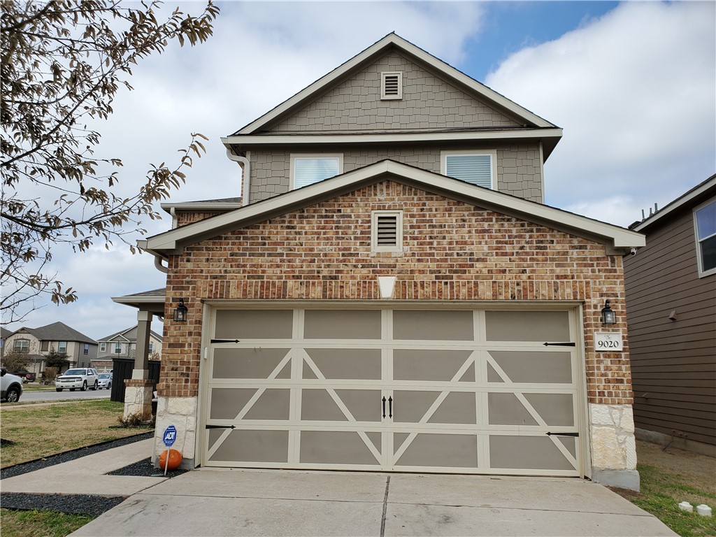 a front view of a house with a garage