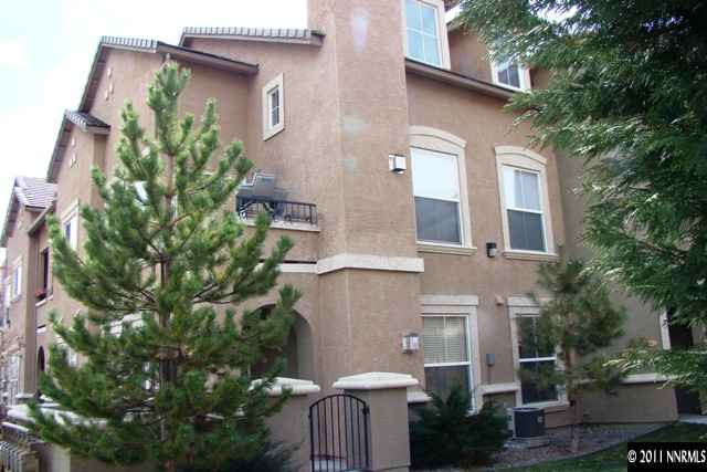 9050 Double R Boulevard, Unit 711 Reno, NV 89521 - Photo 2 of 13 a front view of a house with a garden