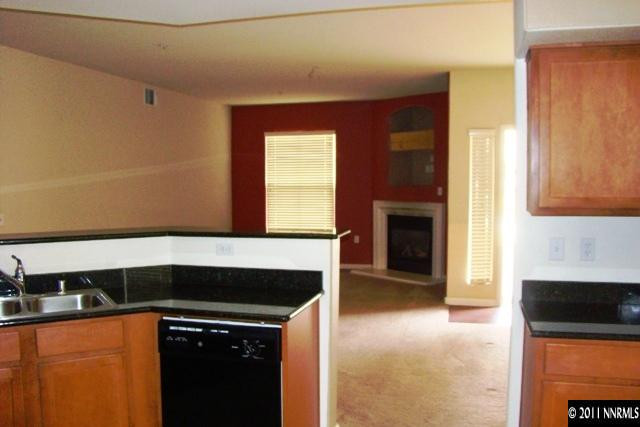 9050 Double R Boulevard, Unit 711 Reno, NV 89521 - Photo 4 of 13 a kitchen with granite countertop a stove and a sink