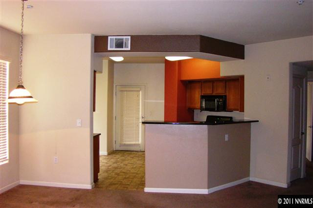 9050 Double R Boulevard, Unit 711 Reno, NV 89521 - Photo 5 of 13 a living room with a couch and a flat screen tv