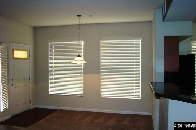 9050 Double R Boulevard, Unit 711 Reno, NV 89521 - Photo 7 of 13 a view of an empty room with a window and a flat screen tv