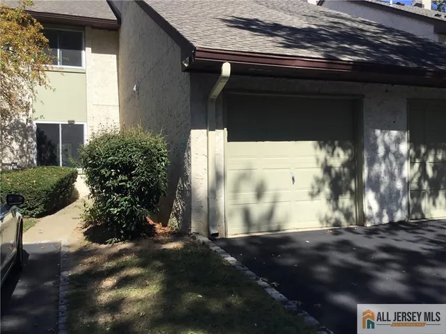 a vase of flowers sitting on a floor