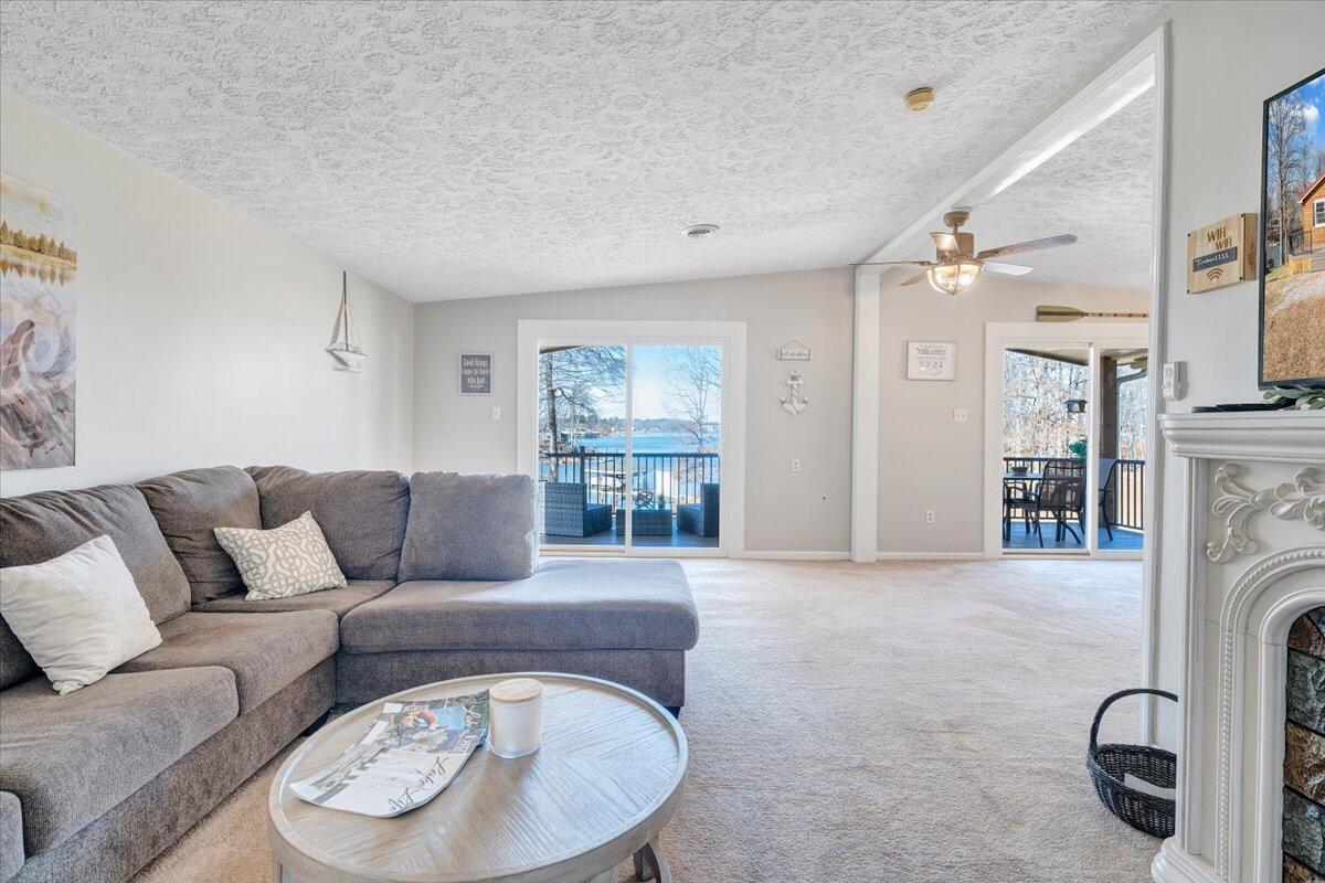 1111 Jefferson Dock Road Penhook, VA 24137 - Photo 12 of 50 a living room with furniture a fireplace and a large window
