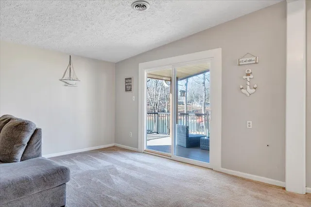 a bedroom with two beds and paintings on the wall