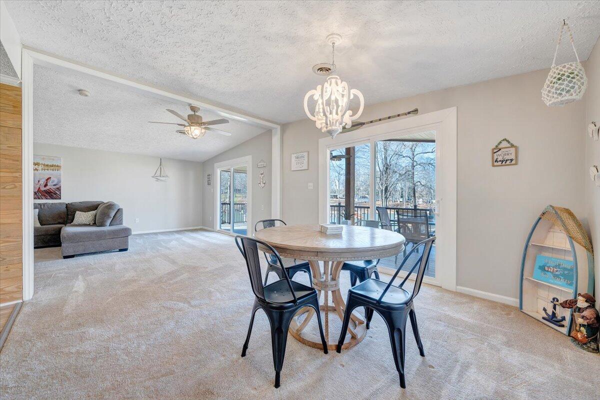 1111 Jefferson Dock Road Penhook, VA 24137 - Photo 15 of 50 a view of a dining room with furniture and a chandelier