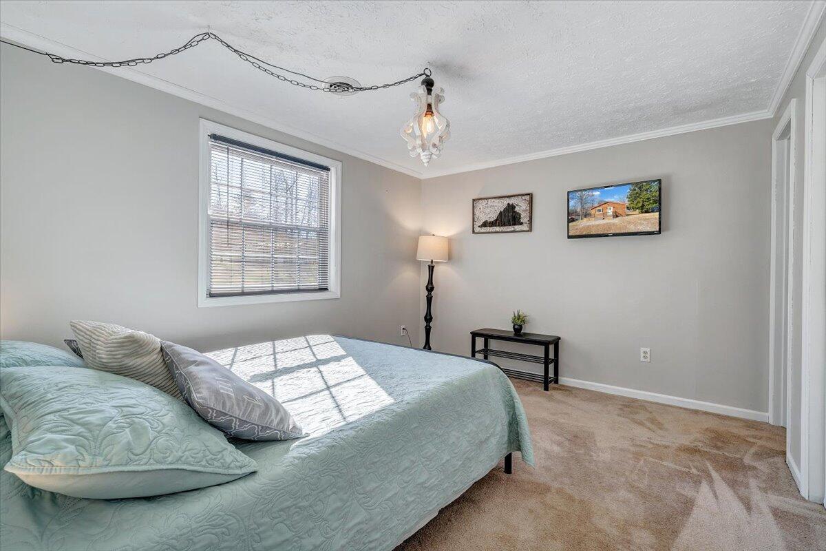 1111 Jefferson Dock Road Penhook, VA 24137 - Photo 23 of 50 a bedroom with a bed and a window