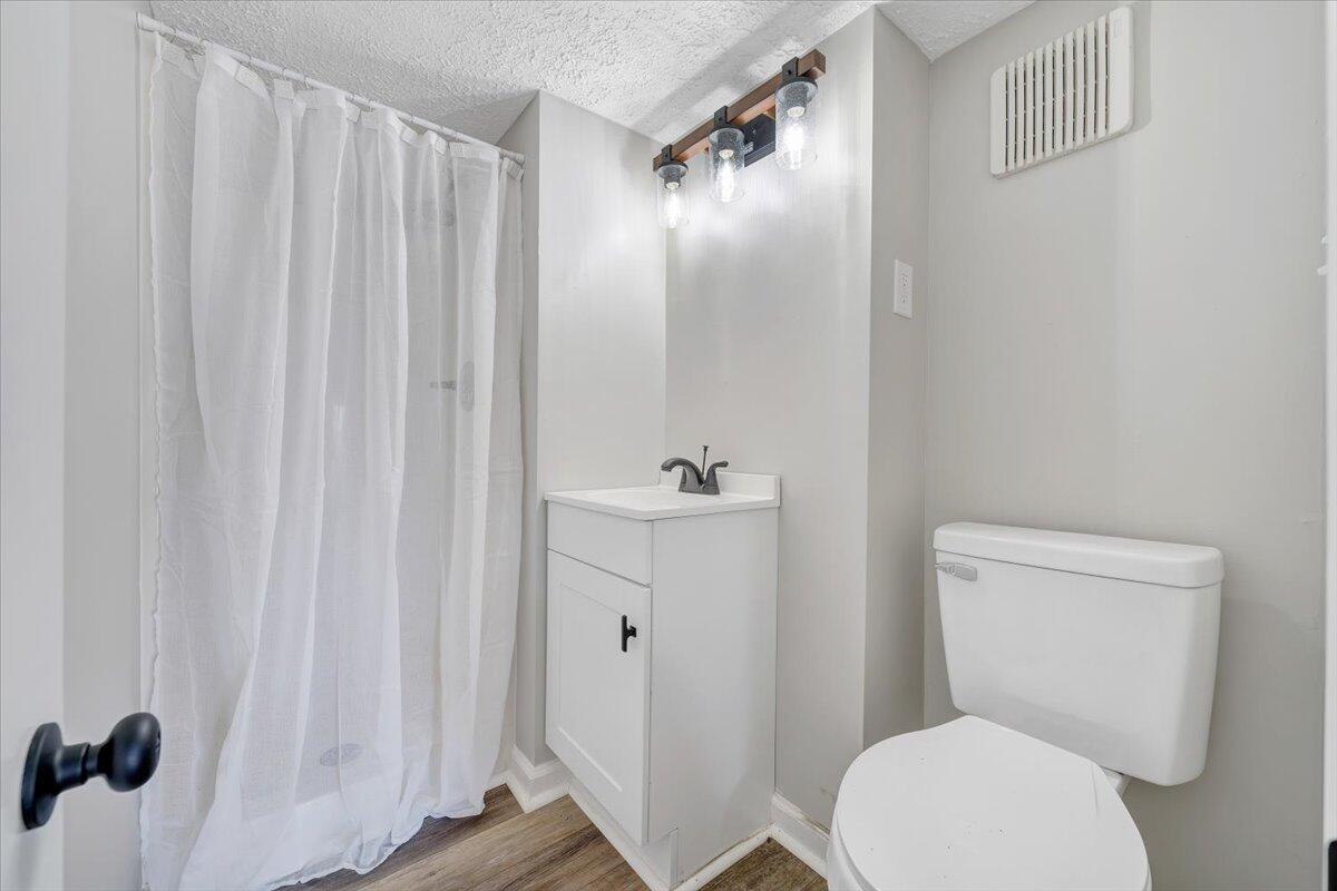 1111 Jefferson Dock Road Penhook, VA 24137 - Photo 31 of 50 a white toilet sitting next to a bathroom sink