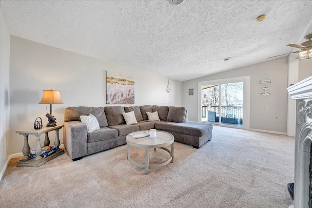 a kitchen with stainless steel appliances kitchen island granite countertop a refrigerator and microwave