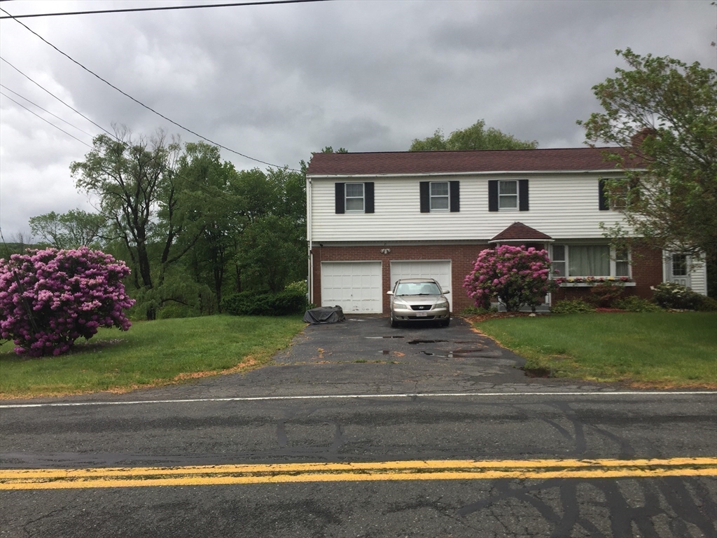 21 Fred Jackson Road Southwick, MA 01077 - Photo 21 of 35 a front view of a house with a yard and garage