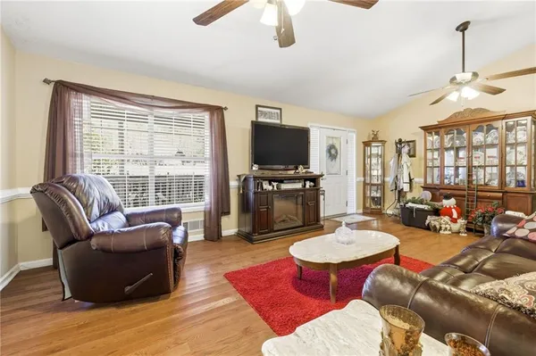 a living room with furniture a fireplace and a flat screen tv