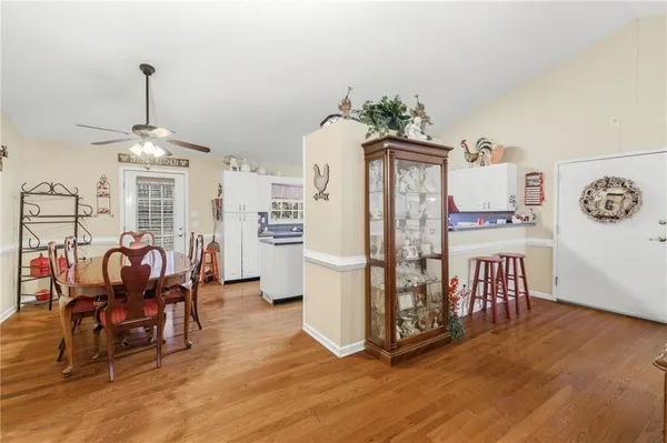 a dining room with furniture entryway and wooden floor