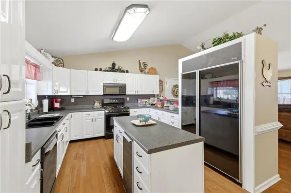 a kitchen with a sink a stove and cabinets