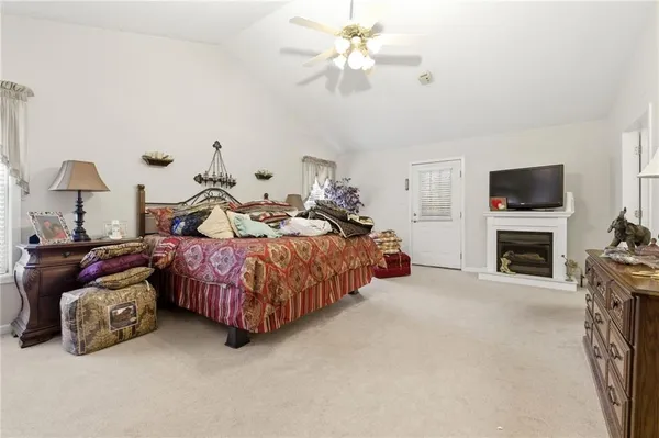 a spacious bedroom with a bed and a fireplace