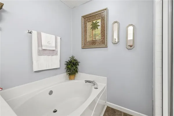 a bathroom with a tub and mirror