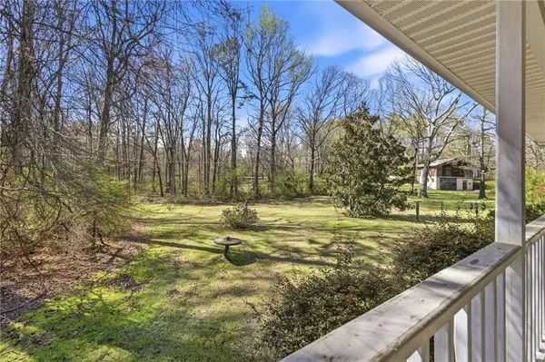 a view of a house with yard and tree s