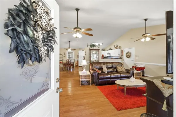a living room with furniture and kitchen view