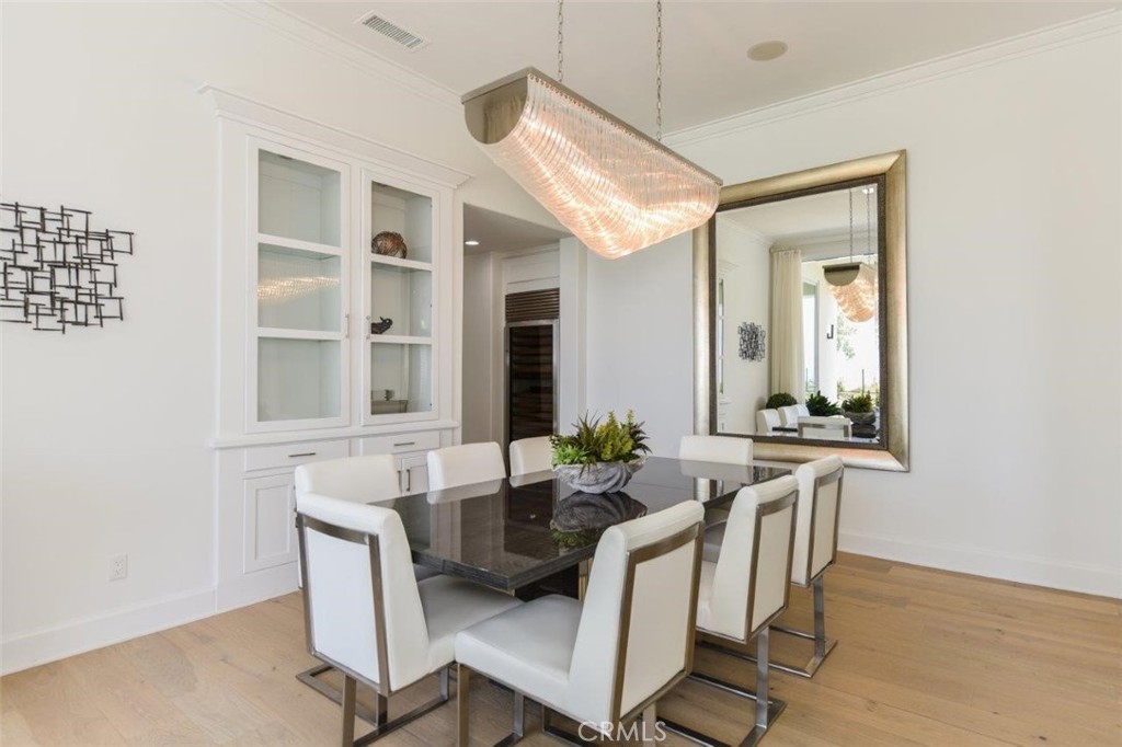 7 Via Brezza Newport Coast, CA 92657 - Photo 19 of 74 a view of a dining room with furniture and wooden floor