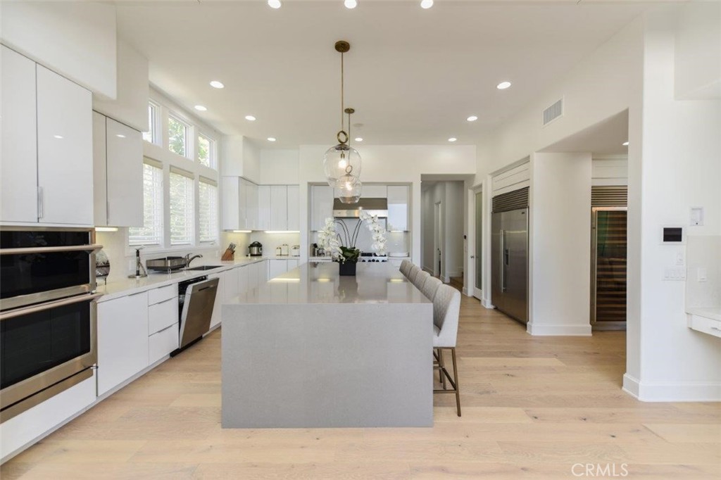 7 Via Brezza Newport Coast, CA 92657 - Photo 28 of 74 a large white kitchen with lots of counter space a sink appliances and cabinets