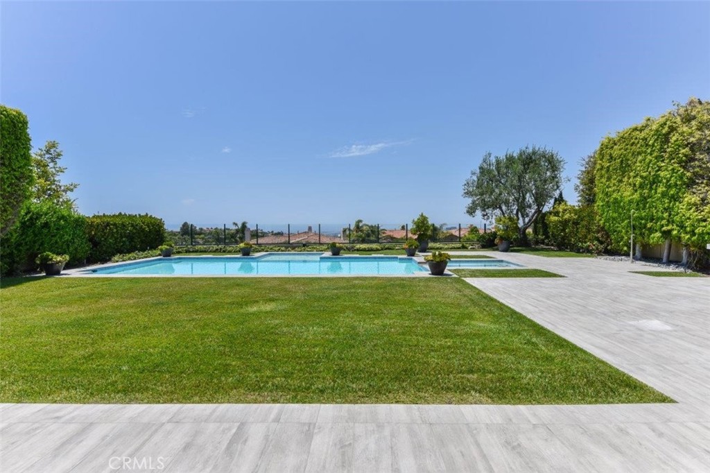 7 Via Brezza Newport Coast, CA 92657 - Photo 65 of 74 a view of a swimming pool with an outdoor space and seating area