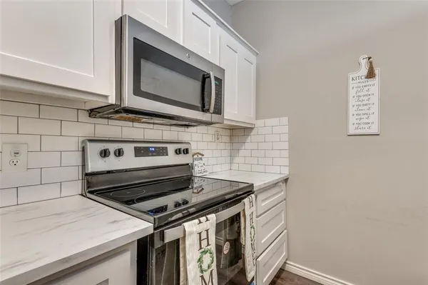 a stove top oven sitting inside of a kitchen