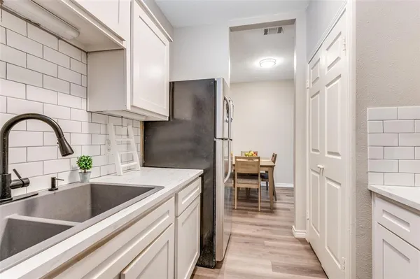 a kitchen with a sink and a refrigerator