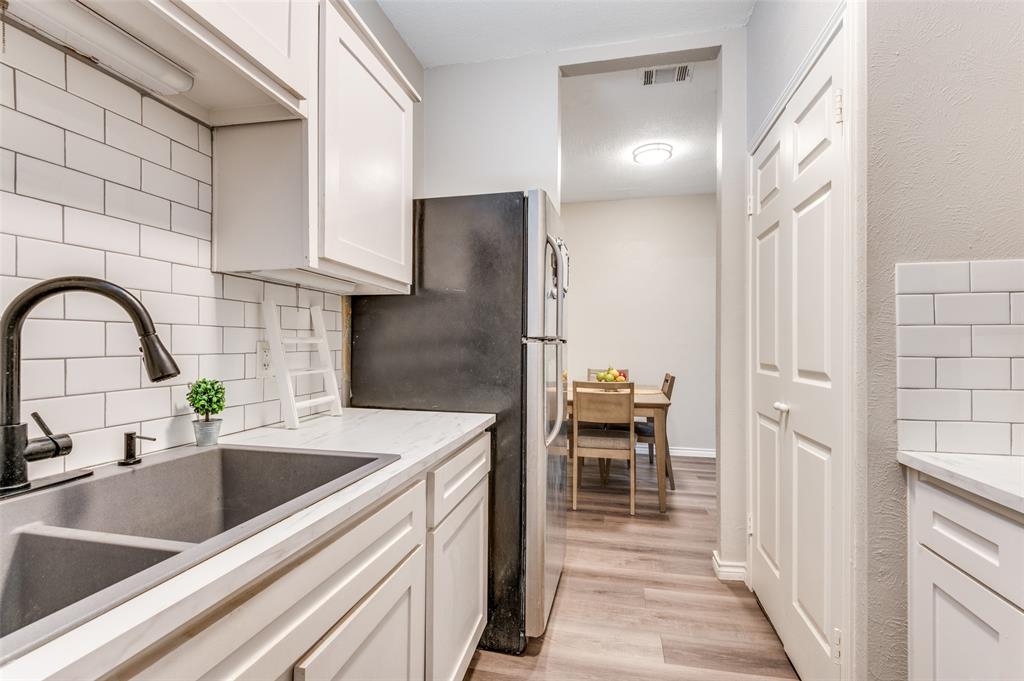 2110 Randy Snow Road, Unit 313 Arlington, TX 76011 - Photo 12 of 25 a kitchen with a sink and a refrigerator