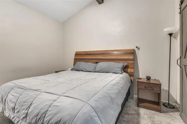 a bedroom with a bed and a table