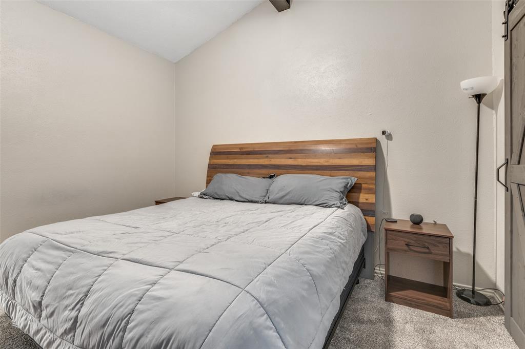 2110 Randy Snow Road, Unit 313 Arlington, TX 76011 - Photo 18 of 25 a bedroom with a bed and a table