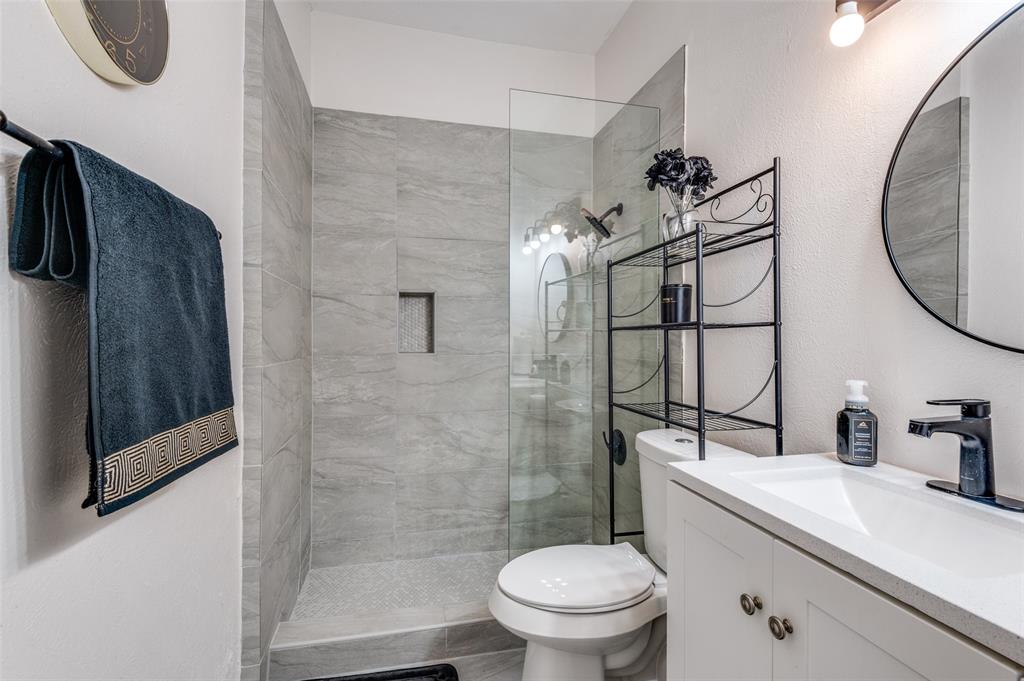 2110 Randy Snow Road, Unit 313 Arlington, TX 76011 - Photo 19 of 25 a bathroom with a sink a toilet and shower