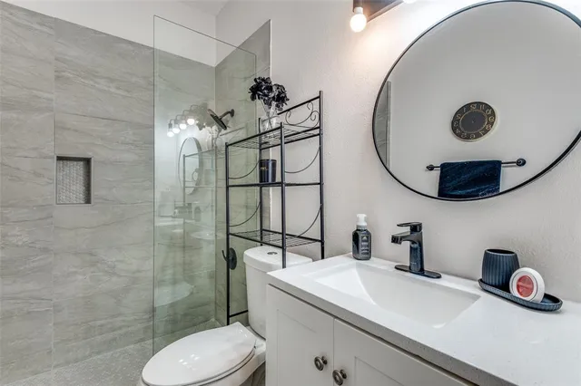 a bathroom with a sink mirror and toilet